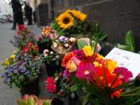 The candlelight and flowers are seen in front of the Roonstrasse Synagogue in Cologne, Germany, on October 7, 2024. (