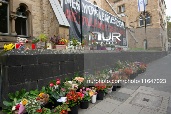 The candlelight and flowers are seen in front of the Roonstrasse Synagogue in Cologne, Germany, on October 7, 2024. 