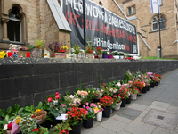 The candlelight and flowers are seen in front of the Roonstrasse Synagogue in Cologne, Germany, on October 7, 2024. (