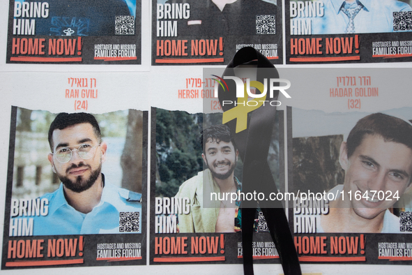 Pictures of kidnapped Israelis are seen in front of the Roonstrasse Synagogue in Cologne, Germany, on October 7, 2024. 