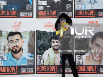 Pictures of kidnapped Israelis are seen in front of the Roonstrasse Synagogue in Cologne, Germany, on October 7, 2024. (