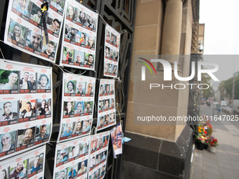 Pictures of kidnapped Israelis are seen in front of the Roonstrasse Synagogue in Cologne, Germany, on October 7, 2024. (