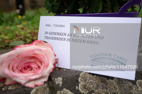 The candlelight and flowers are seen in front of the Roonstrasse Synagogue in Cologne, Germany, on October 7, 2024. 