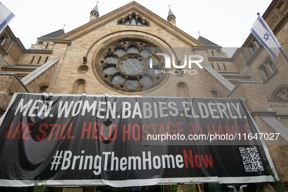 The large banner of ''bringthemhomenow'' hangs on the Roonstrasse Synagogue in Cologne, Germany, on October 7, 2024. 