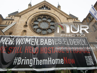 The large banner of ''bringthemhomenow'' hangs on the Roonstrasse Synagogue in Cologne, Germany, on October 7, 2024. (