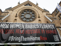 The large banner of ''bringthemhomenow'' hangs on the Roonstrasse Synagogue in Cologne, Germany, on October 7, 2024. (