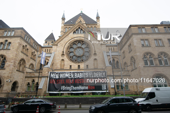 The large banner of ''bringthemhomenow'' hangs on the Roonstrasse Synagogue in Cologne, Germany, on October 7, 2024. 