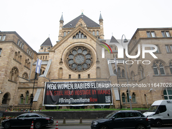 The large banner of ''bringthemhomenow'' hangs on the Roonstrasse Synagogue in Cologne, Germany, on October 7, 2024. (