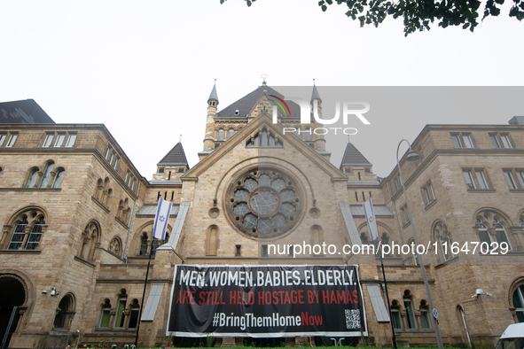 The large banner of ''bringthemhomenow'' hangs on the Roonstrasse Synagogue in Cologne, Germany, on October 7, 2024. 