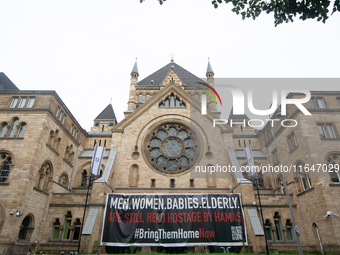 The large banner of ''bringthemhomenow'' hangs on the Roonstrasse Synagogue in Cologne, Germany, on October 7, 2024. (