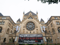 The large banner of ''bringthemhomenow'' hangs on the Roonstrasse Synagogue in Cologne, Germany, on October 7, 2024. (