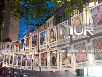 Pictures of killed Palestinians in Gaza are seen hanging during the pro-Palestinian gathering to mark the first anniversary of Israel's atta...