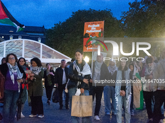 A dozen people gather to mark the first anniversary of Israel's attack on Gaza in Bonn, Germany, on October 7, 2024. (