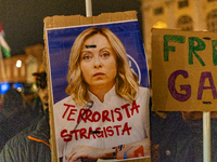 Pro-Palestinian protesters hold up a sign protesting against Prime Minister Meloni during demonstrations in Turin, Italy, on October 7, 2024...