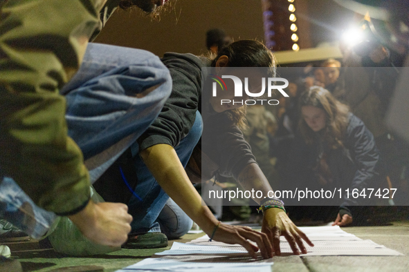 Pro-Palestinian demonstrators in Turin, Italy, project the names of all those killed in Israeli military actions in the Gaza Strip onto the...