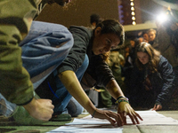 Pro-Palestinian demonstrators in Turin, Italy, project the names of all those killed in Israeli military actions in the Gaza Strip onto the...