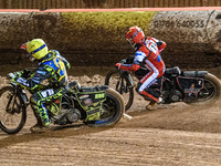 Sheffield Cubs' Ace Pijper rides inside Belle Vue Colts' Sam Hagon in red during the WSRA National Development League match between Belle Vu...