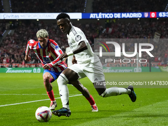 Vinicius Junior left winger of Real Madrid and Brazil and Rodrigo de Paul central midfield of Atletico de Madrid and Argentina compete for t...