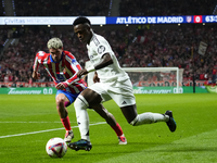 Vinicius Junior left winger of Real Madrid and Brazil and Rodrigo de Paul central midfield of Atletico de Madrid and Argentina compete for t...