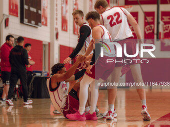 Wisconsin Badgers forward Steven Crowl #22 and guard Max Klesmit #11 help guard John Tonje #9 up off the floor during practice at the Nichol...