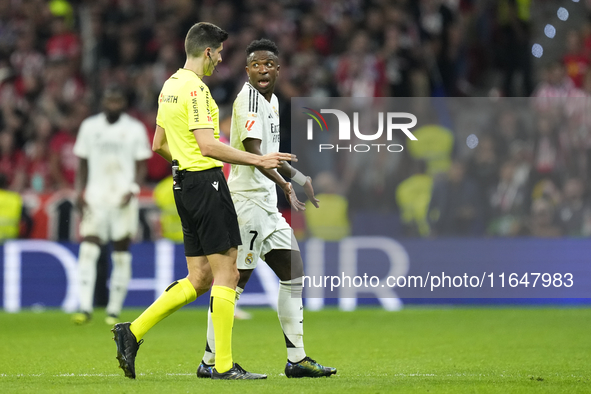 Vinicius Junior left winger of Real Madrid and Brazil talks with the referee during the LaLiga match between Atletico de Madrid and Real Mad...