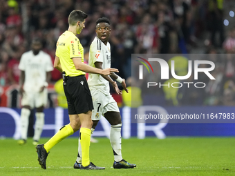 Vinicius Junior left winger of Real Madrid and Brazil talks with the referee during the LaLiga match between Atletico de Madrid and Real Mad...