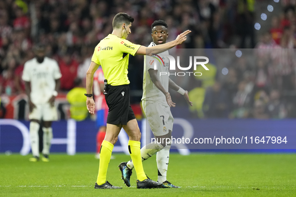 Vinicius Junior left winger of Real Madrid and Brazil talks with the referee during the LaLiga match between Atletico de Madrid and Real Mad...