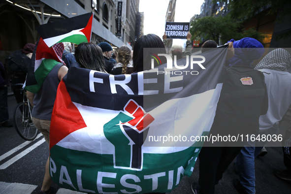 Palestinian supporters march through the streets with flags and signs against the October 2023 Israeli incursion of Gaza, on October 7, 2024...