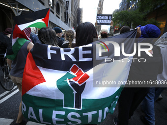 Palestinian supporters march through the streets with flags and signs against the October 2023 Israeli incursion of Gaza, on October 7, 2024...