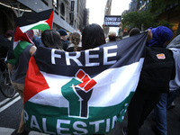 Palestinian supporters march through the streets with flags and signs against the October 2023 Israeli incursion of Gaza, on October 7, 2024...