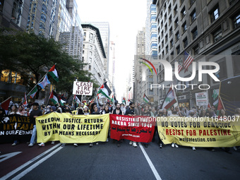 Palestinian supporters march through the streets with flags and signs against the October 2023 Israeli incursion of Gaza, on October 7, 2024...