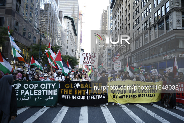 Palestinian supporters march through the streets with flags and signs against the October 2023 Israeli incursion of Gaza, on October 7, 2024...