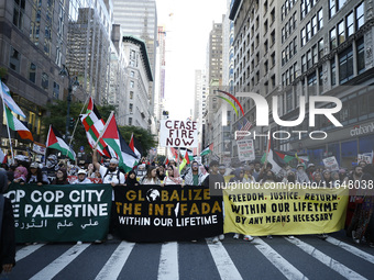 Palestinian supporters march through the streets with flags and signs against the October 2023 Israeli incursion of Gaza, on October 7, 2024...