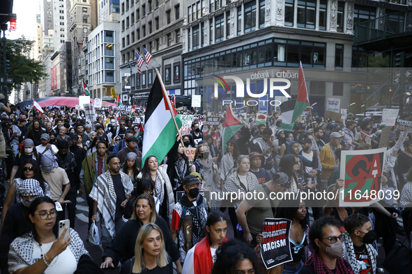 Palestinian supporters march through the streets with flags and signs against the October 2023 Israeli incursion of Gaza, on October 7, 2024...