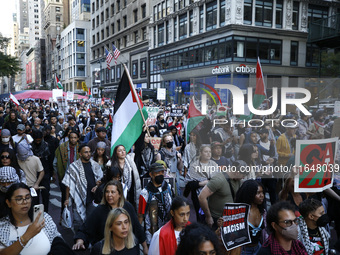 Palestinian supporters march through the streets with flags and signs against the October 2023 Israeli incursion of Gaza, on October 7, 2024...