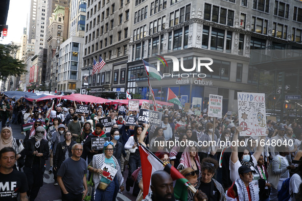 Palestinian supporters march through the streets with flags and signs against the October 2023 Israeli incursion of Gaza, on October 7, 2024...