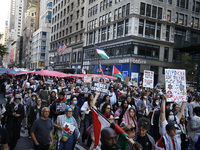 Palestinian supporters march through the streets with flags and signs against the October 2023 Israeli incursion of Gaza, on October 7, 2024...