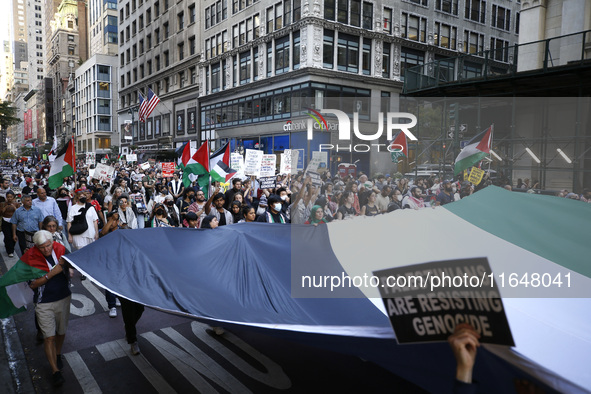 Palestinian supporters march through the streets with flags and signs against the October 2023 Israeli incursion of Gaza, on October 7, 2024...