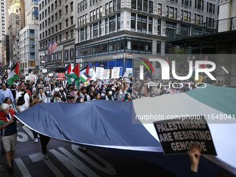 Palestinian supporters march through the streets with flags and signs against the October 2023 Israeli incursion of Gaza, on October 7, 2024...