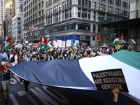 Palestinian supporters march through the streets with flags and signs against the October 2023 Israeli incursion of Gaza, on October 7, 2024...