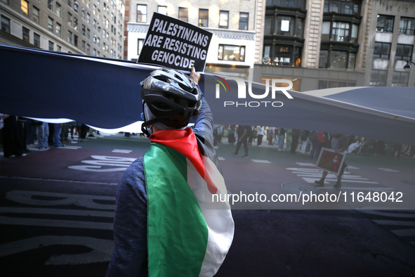 Palestinian supporters march through the streets with flags and signs against the October 2023 Israeli incursion of Gaza, on October 7, 2024...