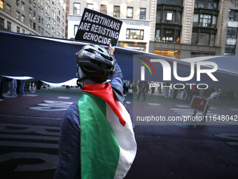 Palestinian supporters march through the streets with flags and signs against the October 2023 Israeli incursion of Gaza, on October 7, 2024...