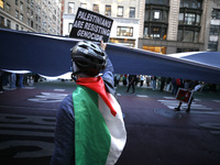 Palestinian supporters march through the streets with flags and signs against the October 2023 Israeli incursion of Gaza, on October 7, 2024...