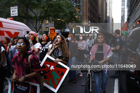 Palestinian supporters march through the streets with flags and signs against the October 2023 Israeli incursion of Gaza, on October 7, 2024...