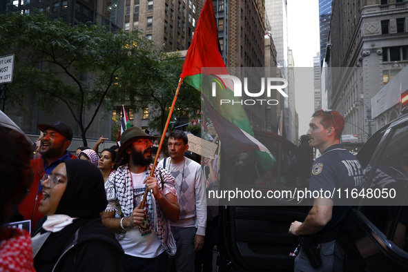 Palestinian supporters march through the streets with flags and signs against the October 2023 Israeli incursion of Gaza, on October 7, 2024...