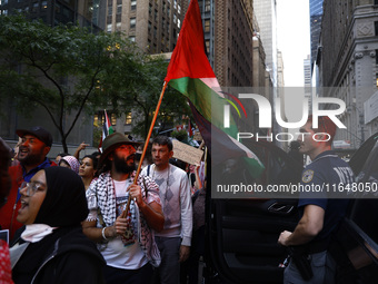 Palestinian supporters march through the streets with flags and signs against the October 2023 Israeli incursion of Gaza, on October 7, 2024...