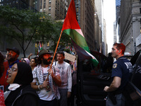 Palestinian supporters march through the streets with flags and signs against the October 2023 Israeli incursion of Gaza, on October 7, 2024...