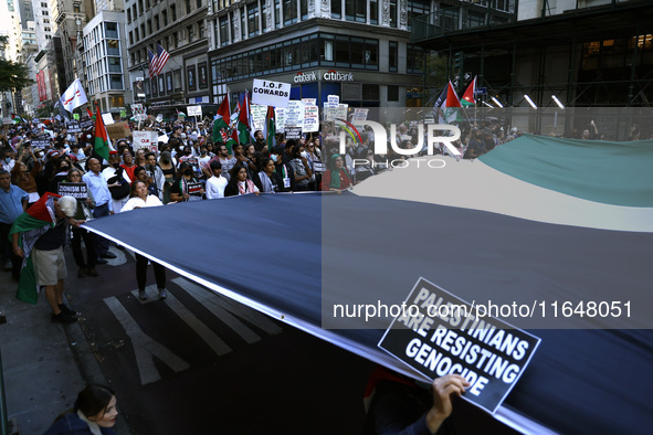 Palestinian supporters march through the streets with flags and signs against the October 2023 Israeli incursion of Gaza, on October 7, 2024...