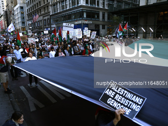 Palestinian supporters march through the streets with flags and signs against the October 2023 Israeli incursion of Gaza, on October 7, 2024...