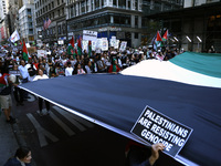 Palestinian supporters march through the streets with flags and signs against the October 2023 Israeli incursion of Gaza, on October 7, 2024...